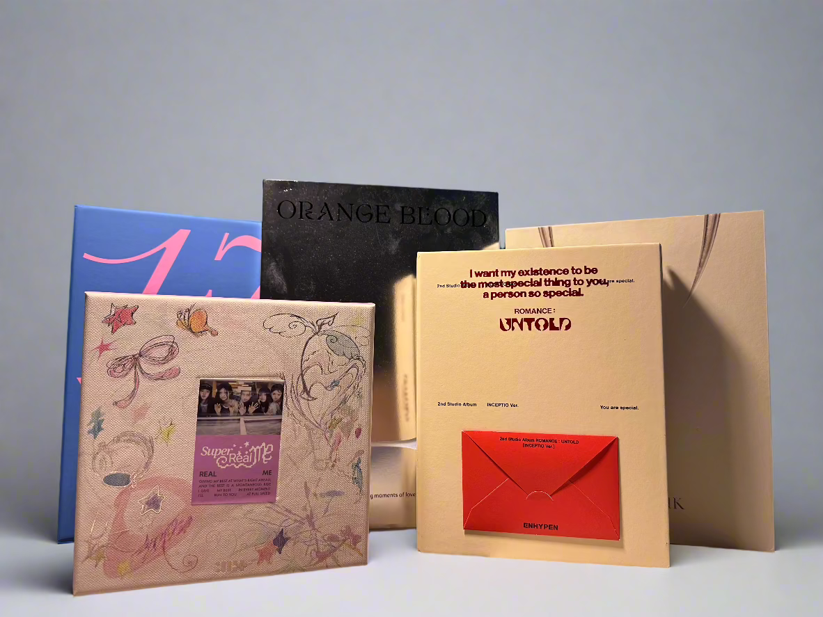 Five K-pop albums: ILLIT, ENHYPEN, BLACKPINK, SEVENTEEN.