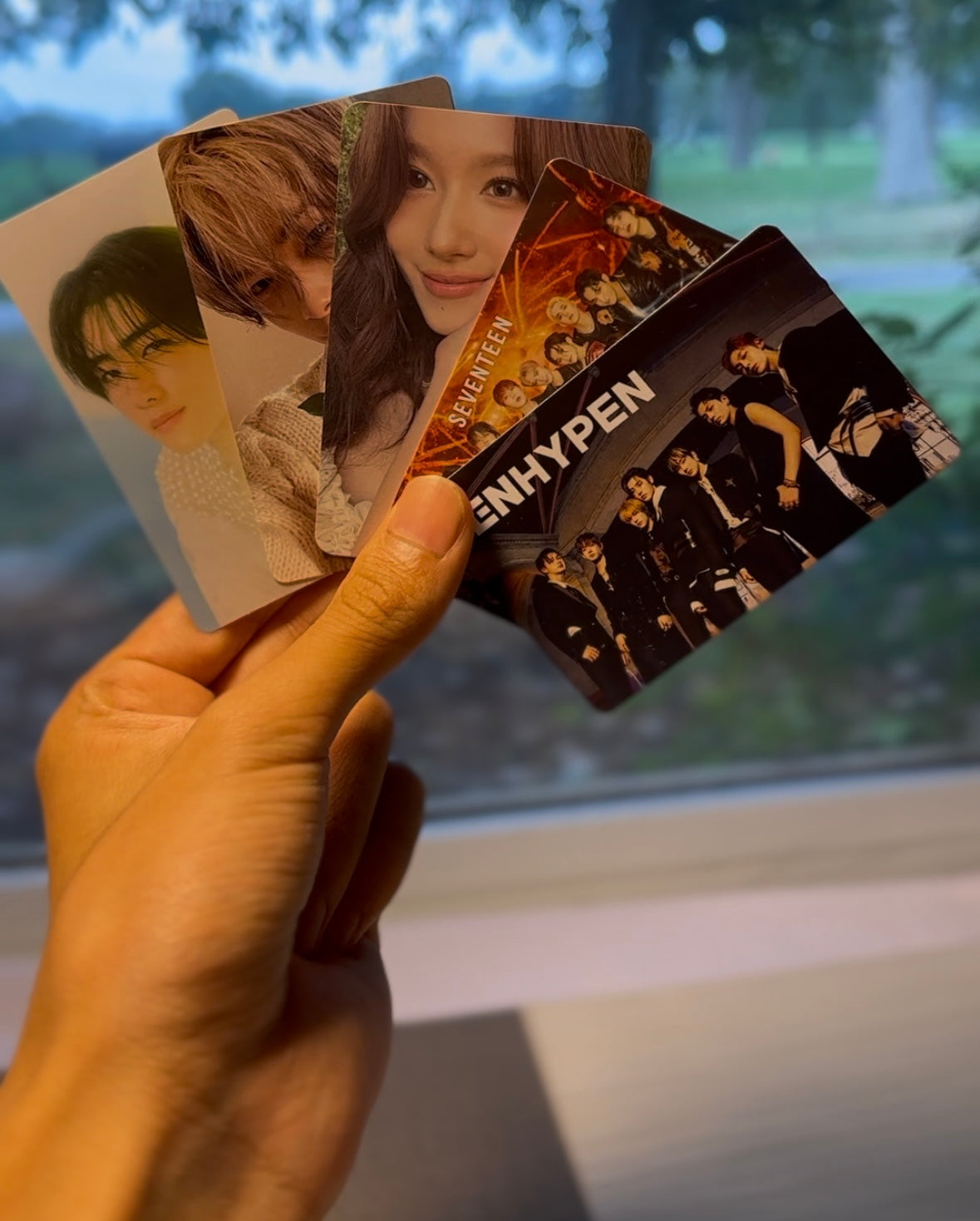 Photocard spread of Sunghoon, Ni-Ki, Sana, Seventeen, and ENHYPEN.